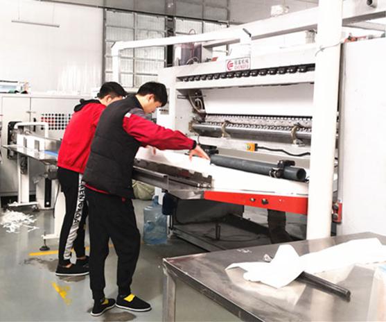 Custom manufacturing process in Top Source Hygiene factory showcasing precision lines