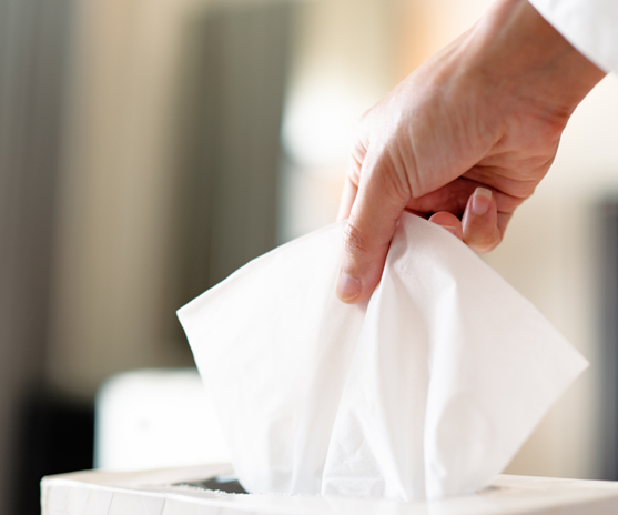 A user applying facial tissue for various purposes in a clean setting