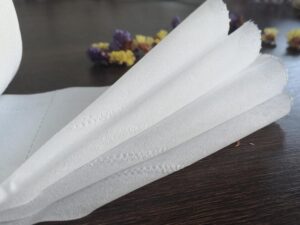 Side-by-side comparison of virgin and recycled toilet paper rolls highlighting key differences