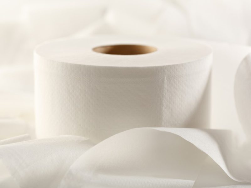 Jumbo roll tissue dispenser in a commercial restroom setting