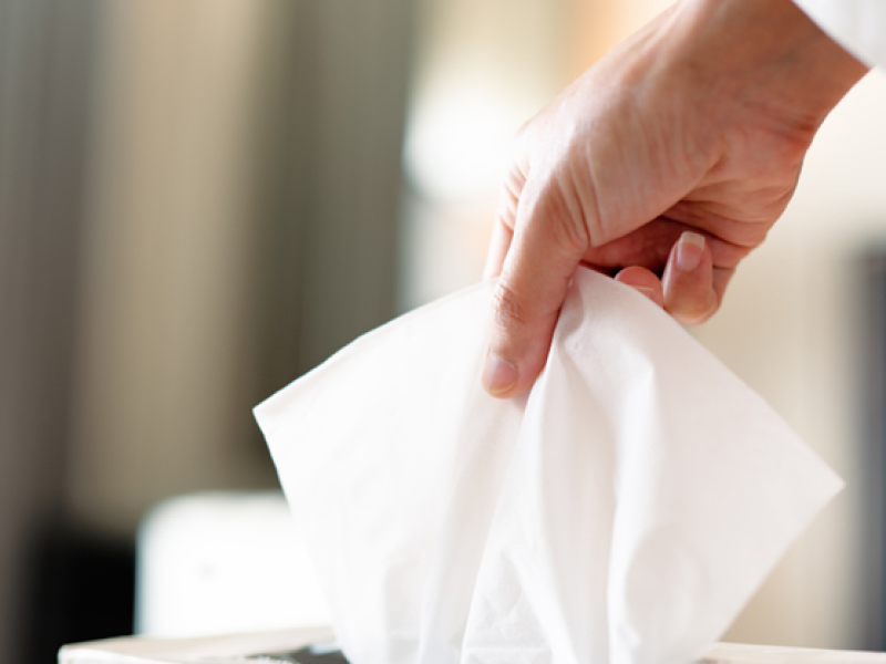 A user applying facial tissue for various purposes in a clean setting